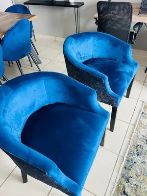 two blue chairs in a room with a table at Hartmanz Laxury Apartments in Pretoria