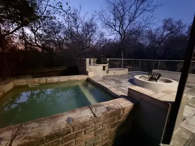 a pool of water with a tub and a sink at Ratel Retreat in Marloth Park