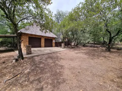 a house with a large yard with a garage at Ratel Retreat in Marloth Park