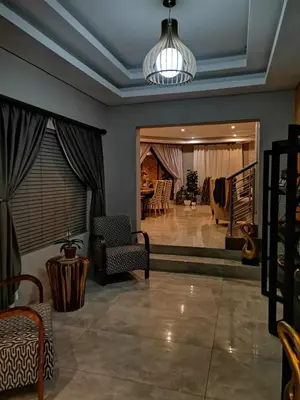 a living room with a pendant light and a lobby at XLA Home-Luxury in Witbank