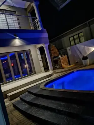 a house with a swimming pool at night at XLA Home-Luxury in Witbank