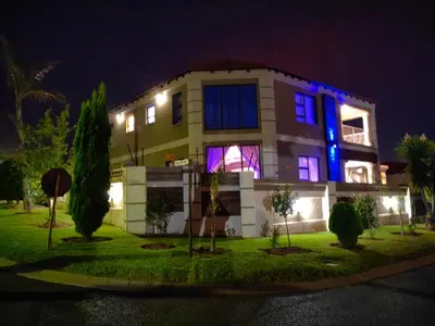 a house with blue and purple lights on it at XLA Home-Luxury in Witbank