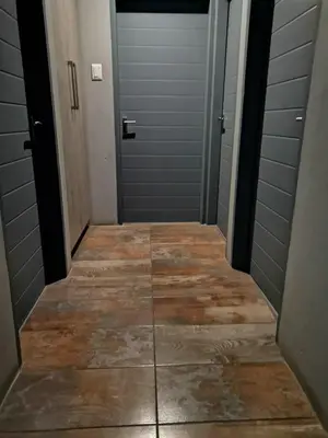 a hallway with two doors and a tile floor at XLA Home-Luxury in Witbank