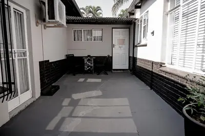 a hallway of a building with a white door and windows at Reveuse in Pretoria