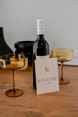 a bottle of wine and two glasses on a table at Reveuse in Pretoria