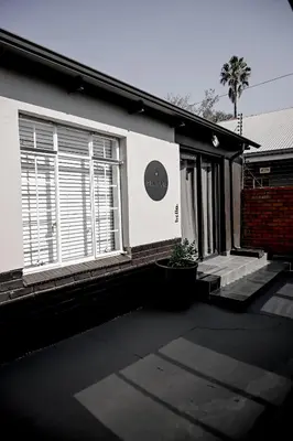 a house with a window with blinds on it at Reveuse in Pretoria