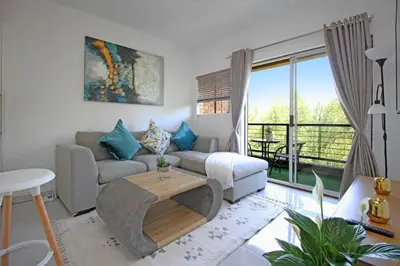 a living room with a couch and a table at VH Apartments have fun with us in Midrand