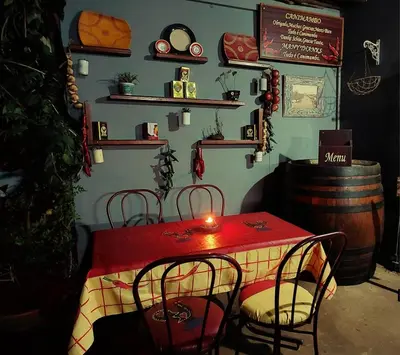 a red table with chairs and a candle on it at Canimambo at The Old Post Office Inn in Graskop