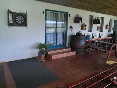 a room with a barrel and a clock on the wall at Canimambo at The Old Post Office Inn in Graskop