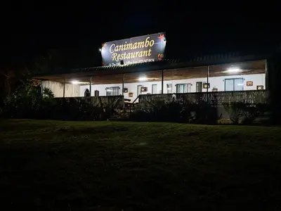 a building with a sign on it at night at Canimambo at The Old Post Office Inn in Graskop