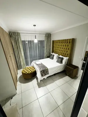 a bedroom with a bed and a large window at Joe's The Blyde in Pretoria