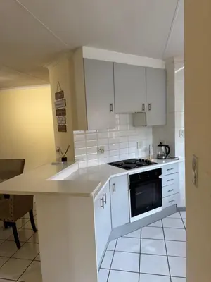 a kitchen with white cabinets and a stove top oven at Tendani Full-House in Centurion