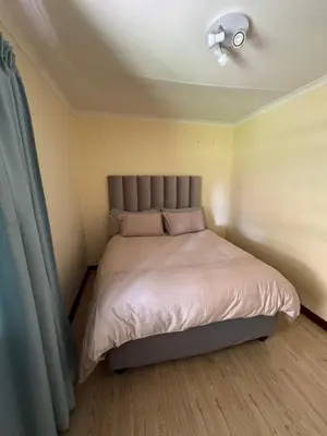 a bed in a small room with a ceiling at Tendani Full-House in Centurion