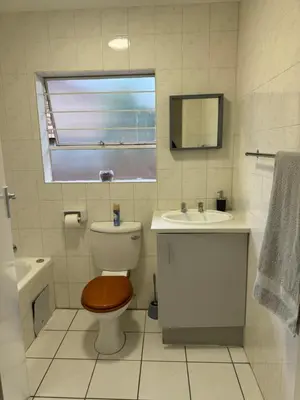 a bathroom with a toilet and a sink at Tendani Full-House in Centurion