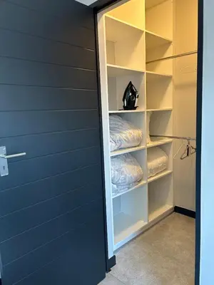 a walk in closet with a door open at Stylish Waterfall Apartment -Braai ,Fast WiFi, Pool in Midrand