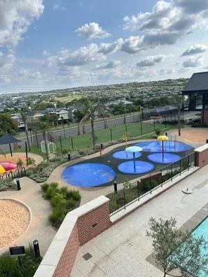 an overhead view of two pools with umbrellas at Stylish Waterfall Apartment -Braai ,Fast WiFi, Pool in Midrand