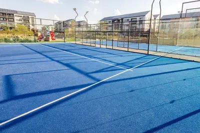 a tennis court with a net on it at Stylish Waterfall Apartment -Braai ,Fast WiFi, Pool in Midrand