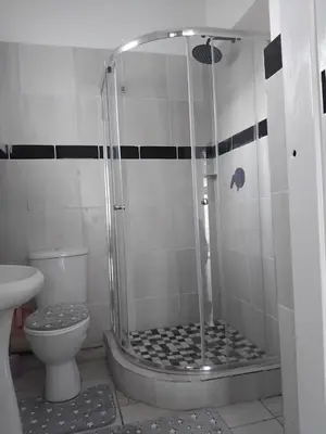 a bathroom with a shower and a toilet at Claremont Secured Accommodation in Pretoria