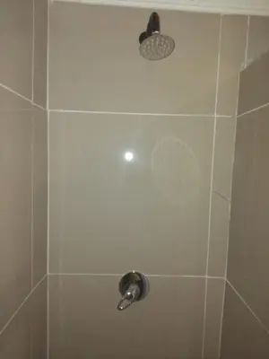 a shower with a shower head in a bathroom at Claremont Secured Accommodation in Pretoria