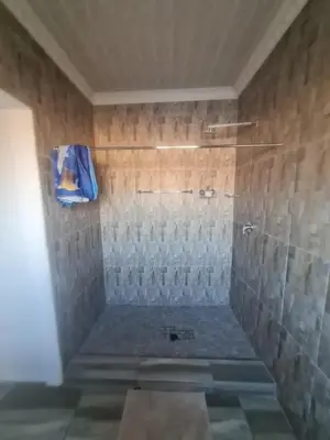 a bathroom with a shower with glass tiles at Divine villa in Louis Trichardt