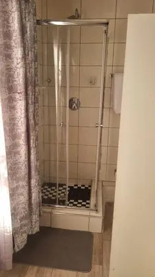 a shower with a glass door in a bathroom at Divine villa in Louis Trichardt
