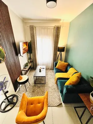a living room with a couch and a table at Classy 1 bed in Midrand at 93 on New Estate in Midrand