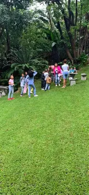 a group of people standing in a park at The Palace Guest House in Pretoria
