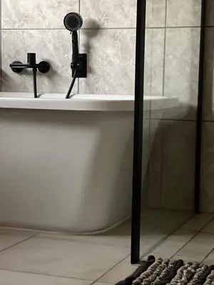 a bathroom with a bath tub with a shower at PebetseLuxury Holiday home in Kempton Park