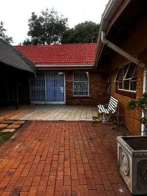 a brick house with a red roof and a brick patio at PebetseLuxury Holiday home in Kempton Park