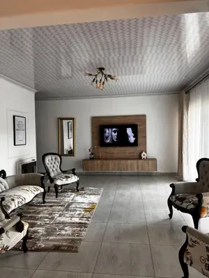 a living room with a couch and a flat screen tv at PebetseLuxury Holiday home in Kempton Park