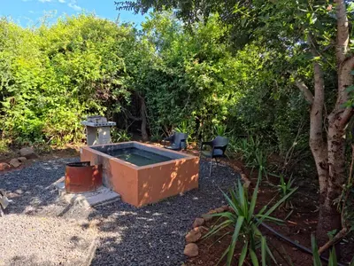 an outdoor hot tub in a yard with trees at Hartbeest Bush Stay #6 in Hartbeespoort