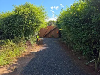 a path between two hedge hedges in a garden at Hartbeest Bush Stay #6 in Hartbeespoort
