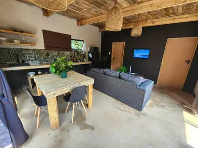 a living room with a table and a couch at Hartbeest Bush Stay #6 in Hartbeespoort