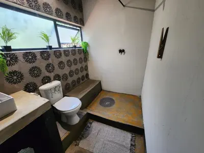 a small bathroom with a toilet and a window at Hartbeest Bush Stay #6 in Hartbeespoort