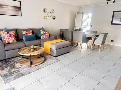 a living room with a couch and a table at Three bedrooms Apartment at The Blyde Lagoons PTA in Pretoria