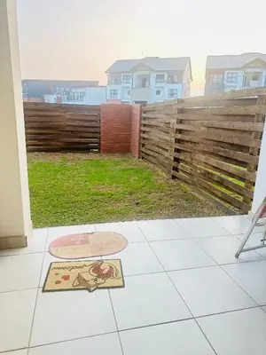 a patio with a fence and a sign on the ground at Three bedrooms Apartment at The Blyde Lagoons PTA in Pretoria