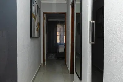 a hallway leading to a room with a chair in it at Luxe Living in Nelspruit