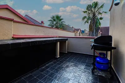 a balcony with a grill on the side of a building at Luxe Living in Nelspruit