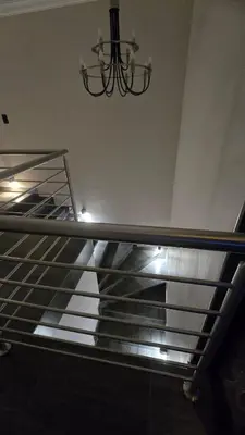 a metal staircase with a chandelier in a building at Lavender Lofts in Centurion