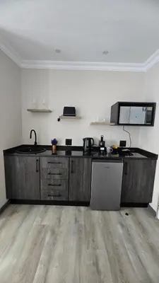 a kitchen with a wooden counter top in a room at Lavender Lofts in Centurion
