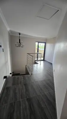 an empty room with a staircase and a chandelier at Lavender Lofts in Centurion
