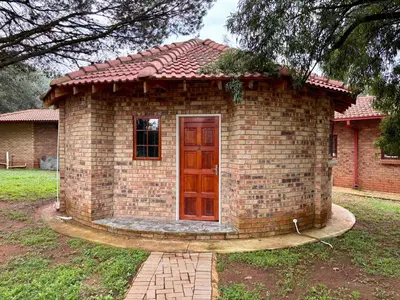 a small brick house with a door in a yard at Pazuri Homestay in Kempton Park