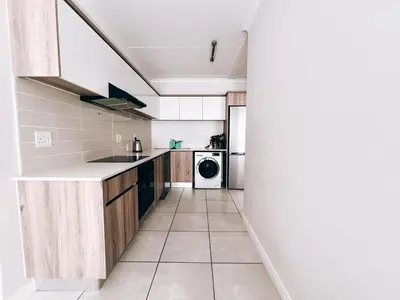 a kitchen with a sink and a dishwasher at Luxurious 1-Bedroom Apartment at The Blyde, Pretoria in Pretoria
