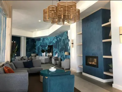 a living room with a couch and a fireplace at Luxurious 1-Bedroom Apartment at The Blyde, Pretoria in Pretoria