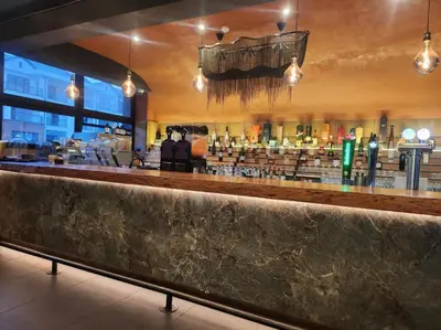 a bar in a restaurant with a lot of shelves at Luxurious 1-Bedroom Apartment at The Blyde, Pretoria in Pretoria