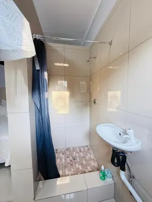 a bathroom with a sink and a shower at Relax Guest House in Ermelo