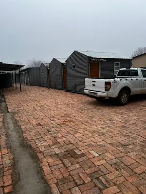 a white truck parked in a brick driveway at Relax Guest House in Ermelo