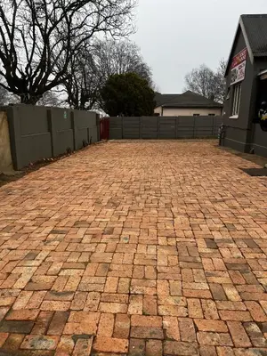 a brick driveway in front of a house at Relax Guest House in Ermelo