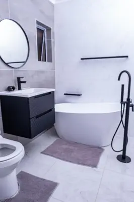 a bathroom with a tub and a toilet and a sink at Flora Haven in Polokwane