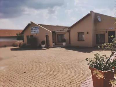 a house with a brick driveway in front of it at KILIMANJARO Guest House in Middelburg